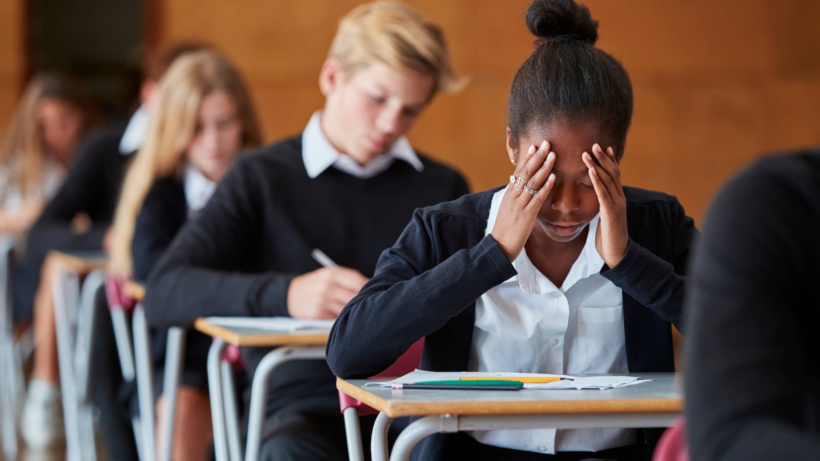 A row of schoolchildren with one looking anxious