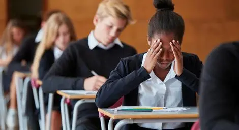 A row of schoolchildren with one looking anxious