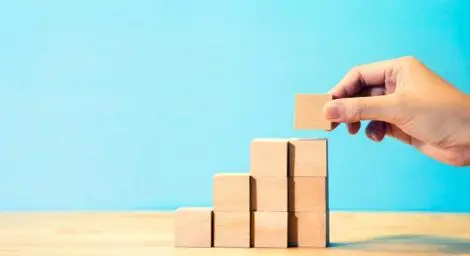 Someone building with wooden blocks