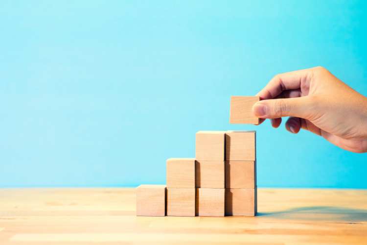Someone building with wooden blocks