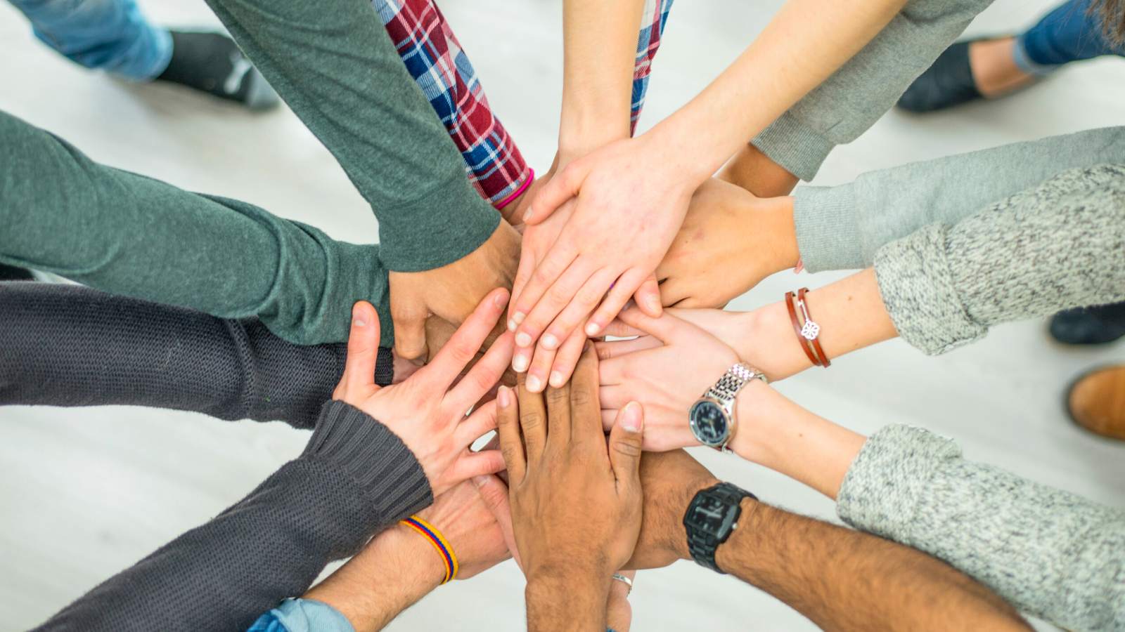 People putting their hands together as a team