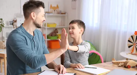 father and son high-fiving