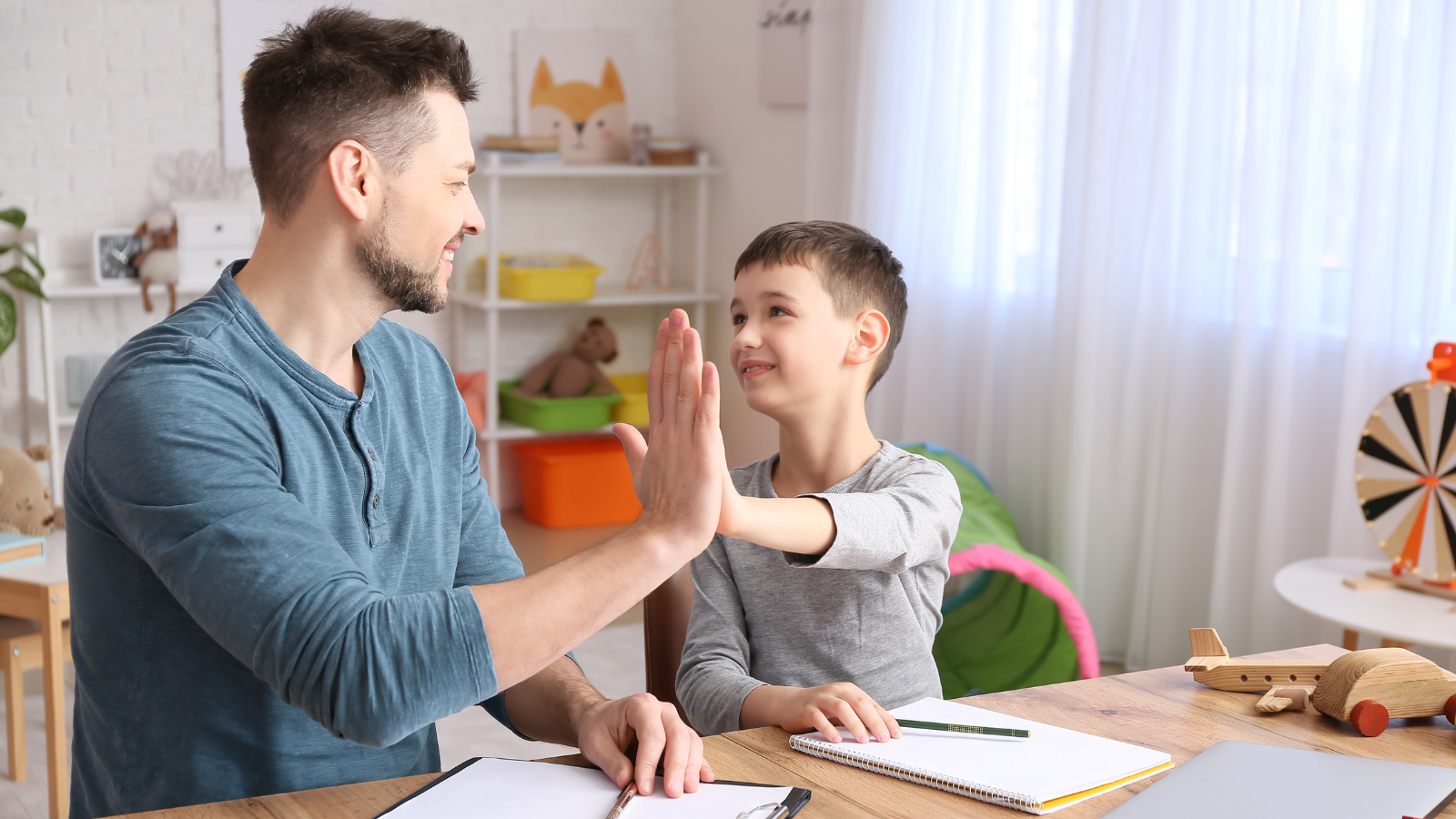 father and son high-fiving
