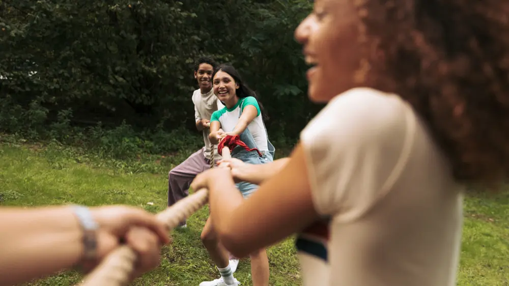 Teenagers playing tug of war