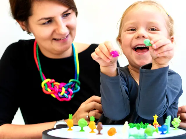 Child playing with toys on a peg board with a woman helping her