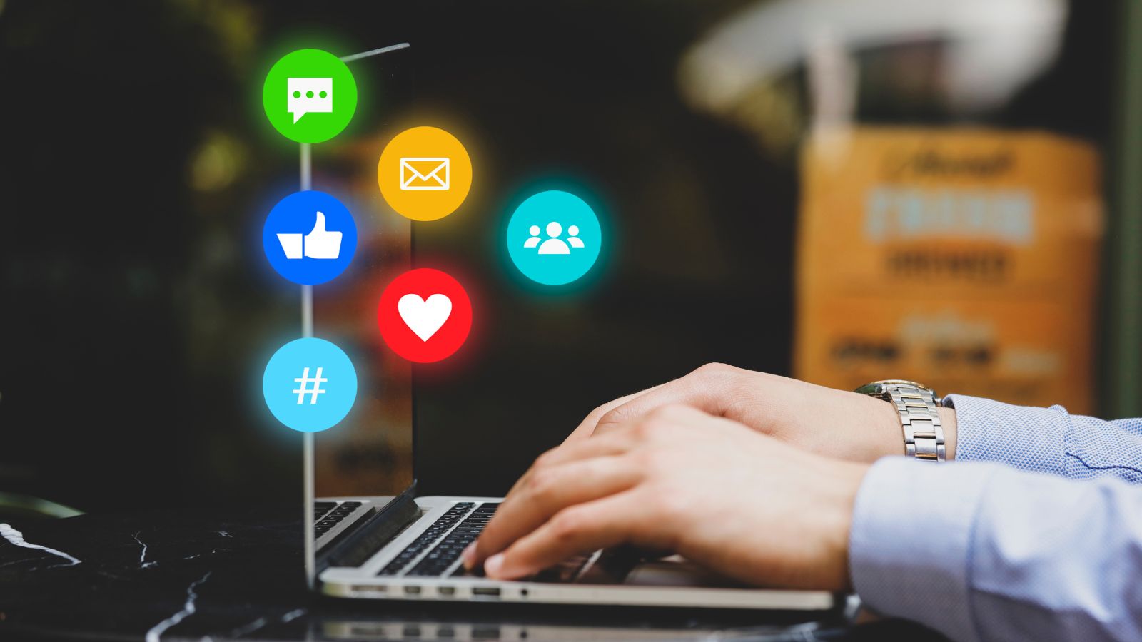 Someone using a laptop, with social media icons in background