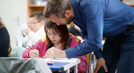 teacher helping child