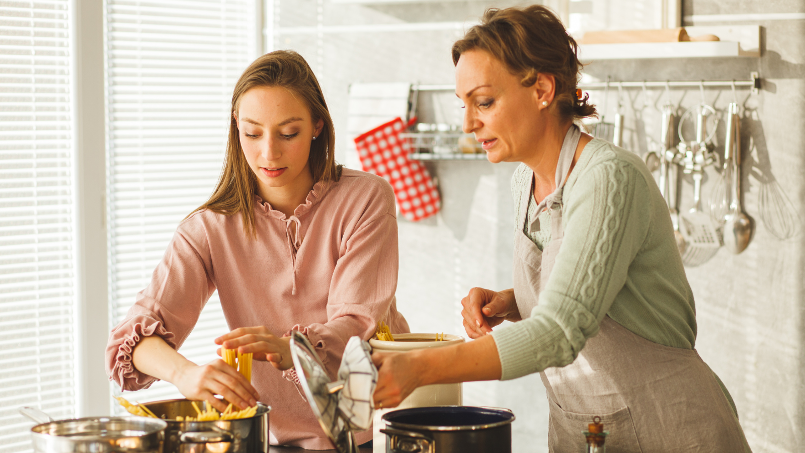 Two women cooking pasta