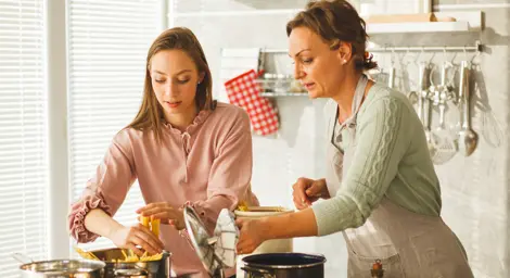 Two women cooking pasta